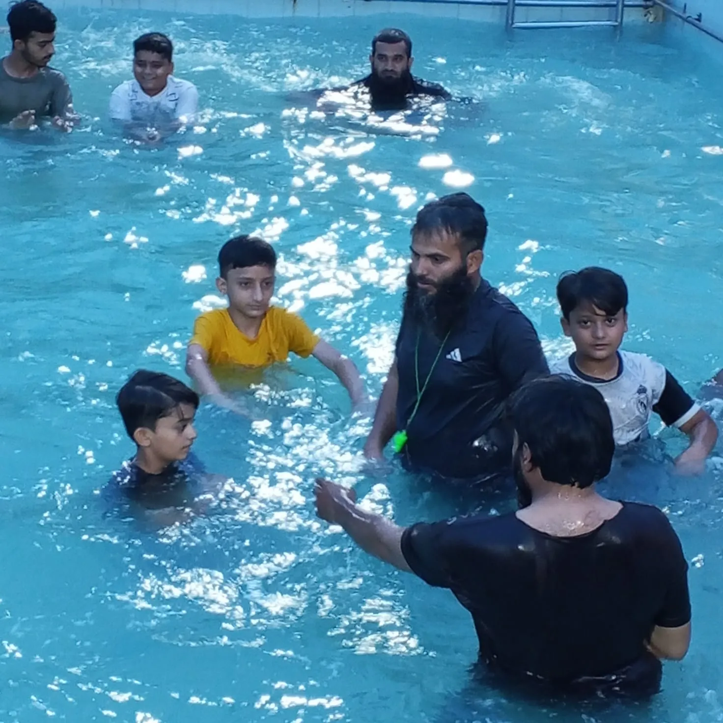Real children's swimming training with Mr. Zeeshan: patient coaching in the water.
