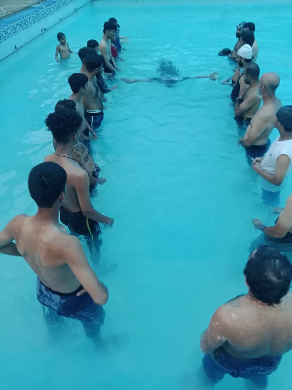 Zeeshan demonstrating swimming technique in the water.