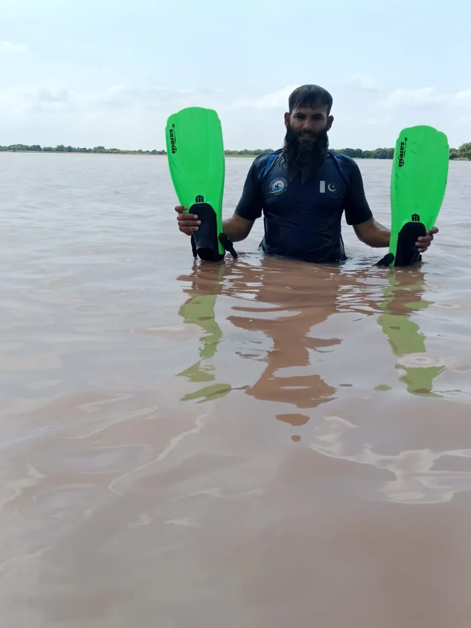 Mr. Zeeshan standing with swimming fins during training.